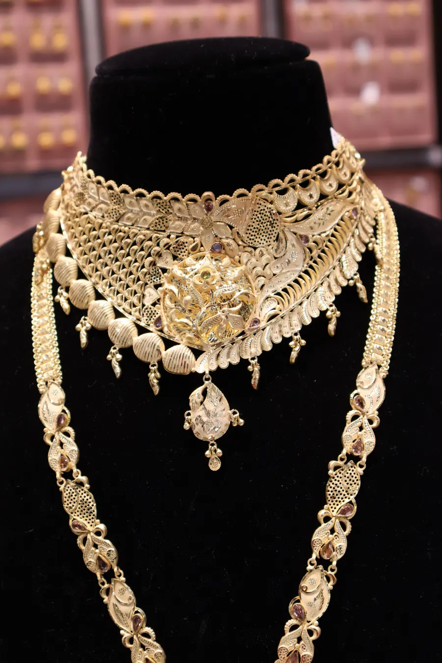 A bridal choker and long necklace set on a black bust