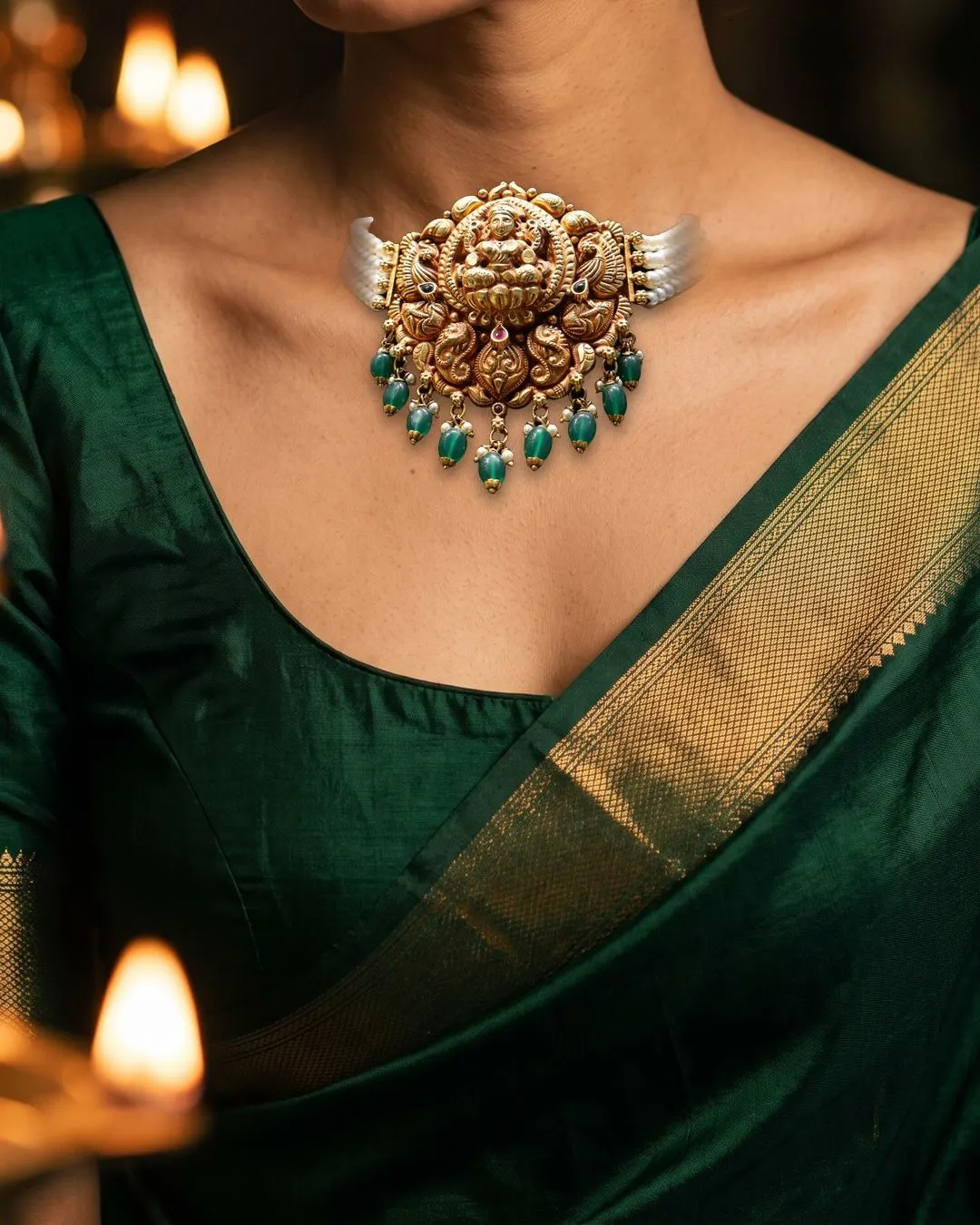 Our Lakshmi choker on pearl strands, worn with a green silk saree